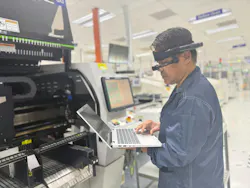 An operator at the Singapore plant uses augmented reality (AR) glasses to engage with the plant's GenAI-powered maintenance copilot software.
