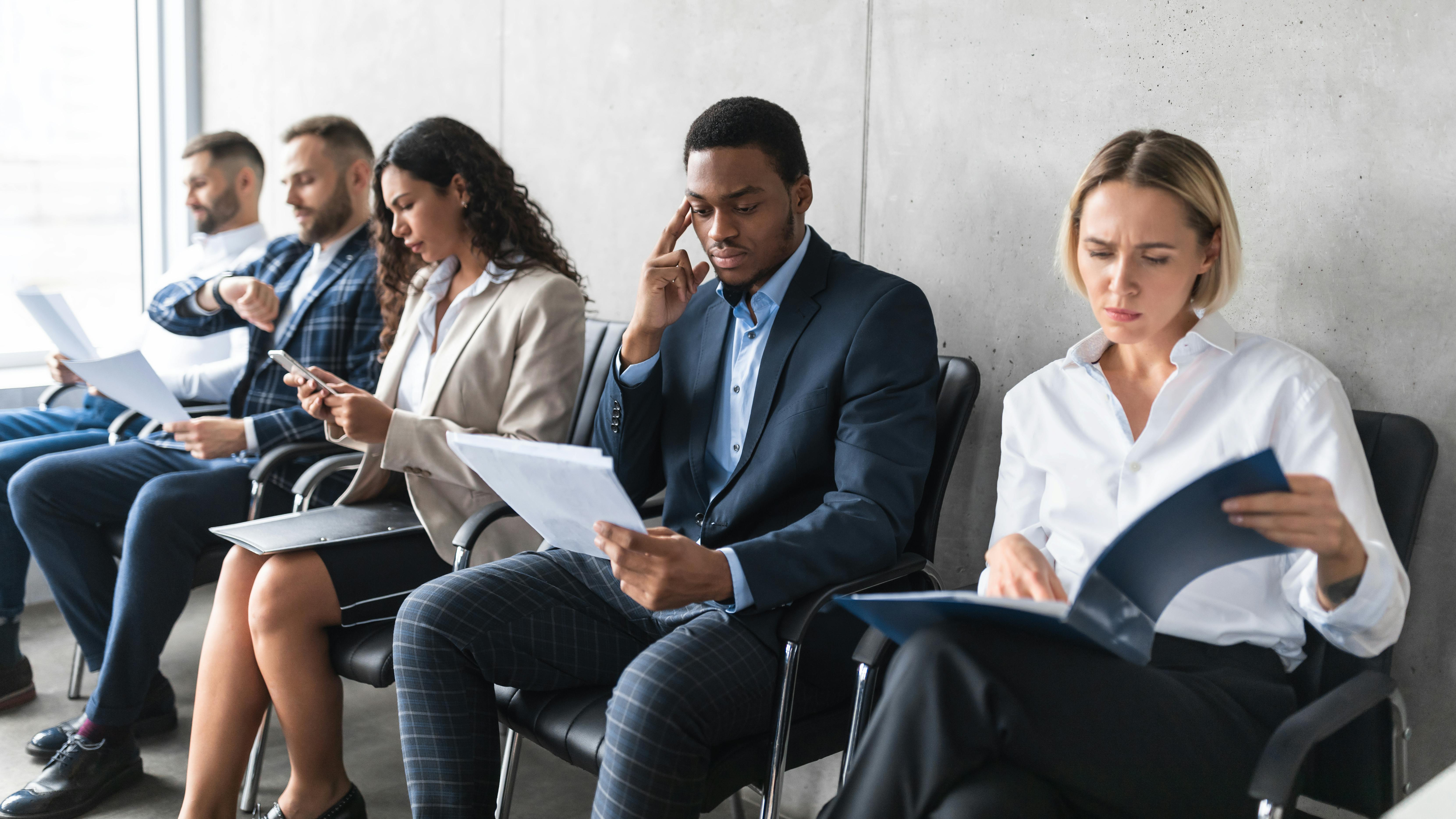 Business people with resumes waiting for job interview