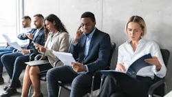 Business people with resumes waiting for job interview