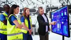 people gathered around a whiteboard covered in data