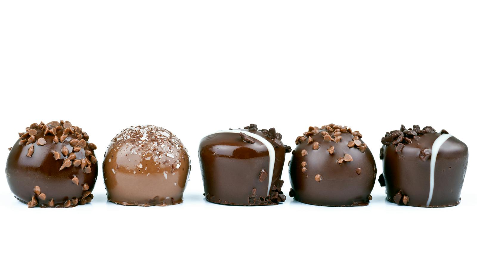 line of chocolates against a white background