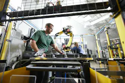 Deron Werts and Maggie Johnson-Schmidt performing maintenance on a robotic cell.