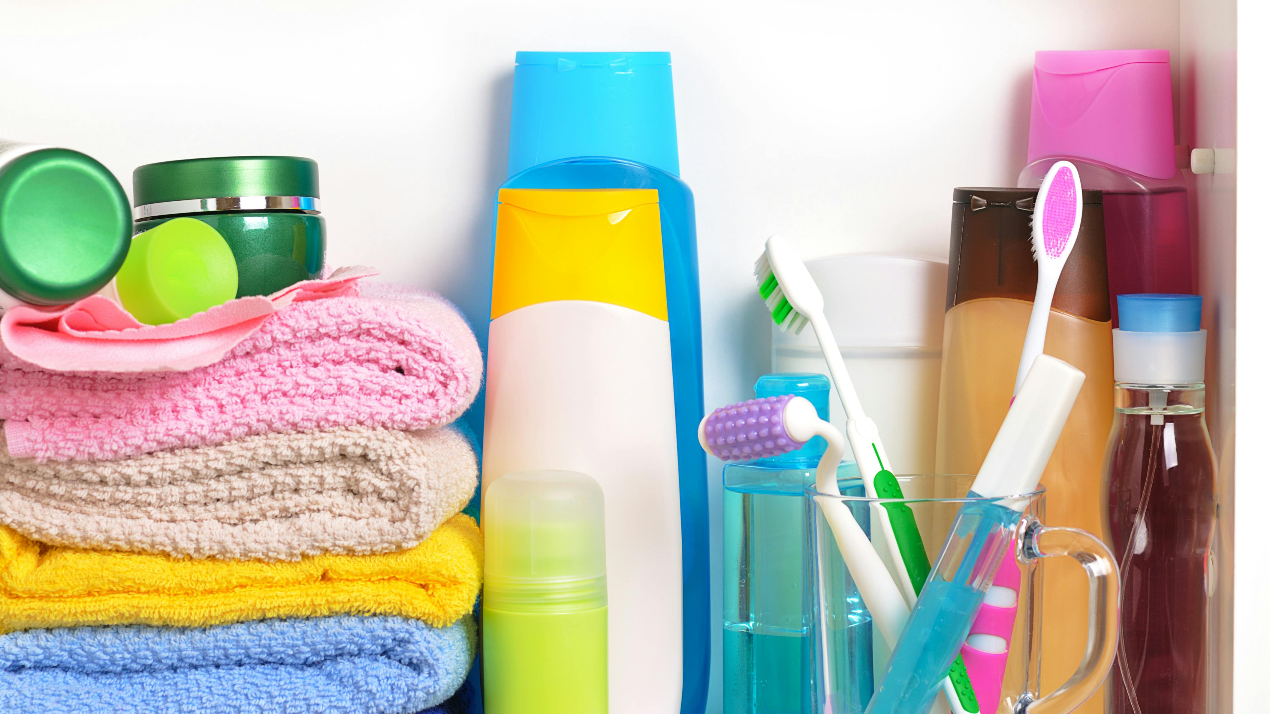 White bathroom shelf with cosmetics and toiletries
