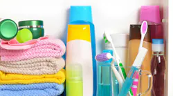 White bathroom shelf with cosmetics and toiletries
